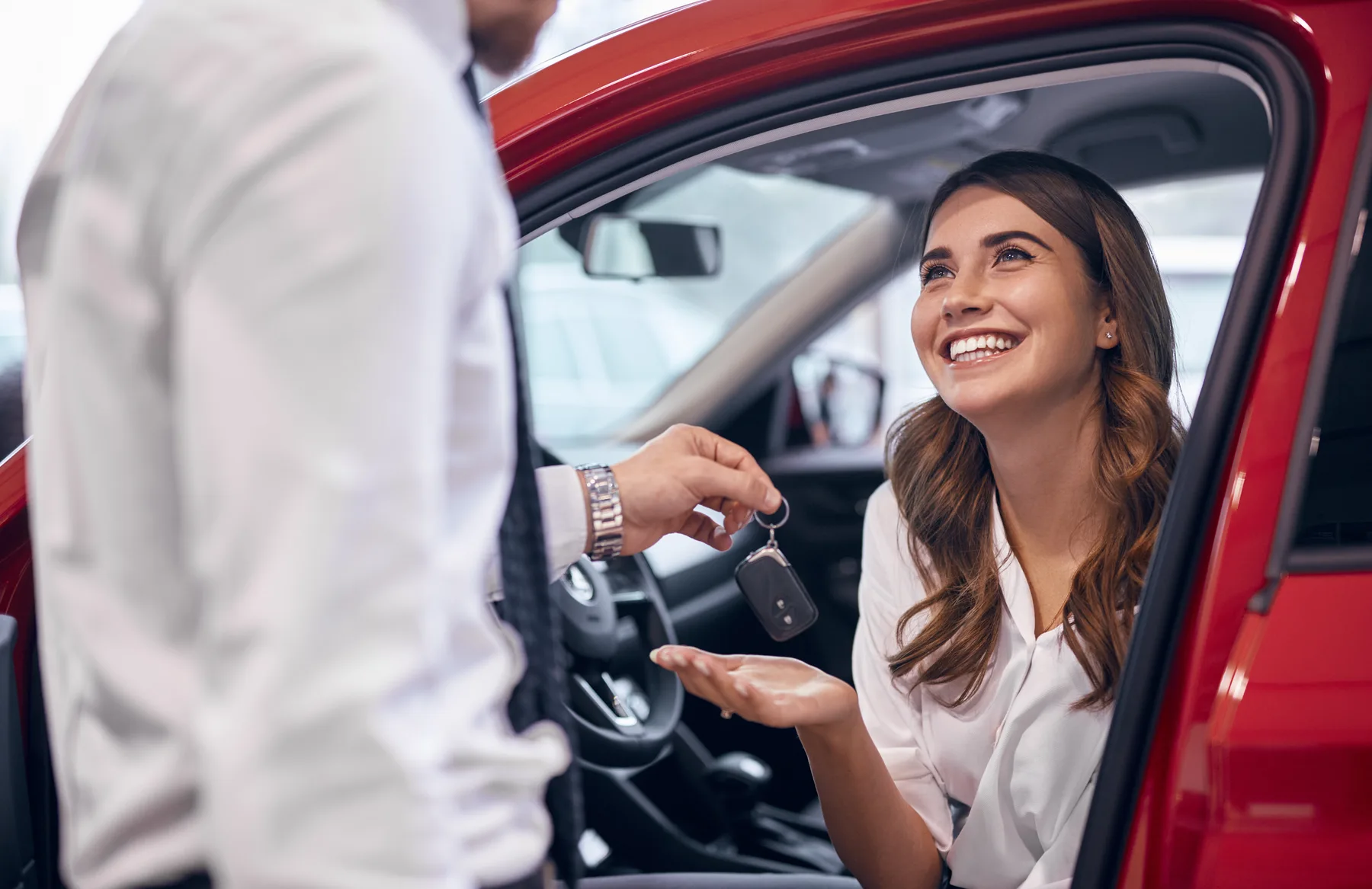 Customer receiving car keys from a Torque sales associate