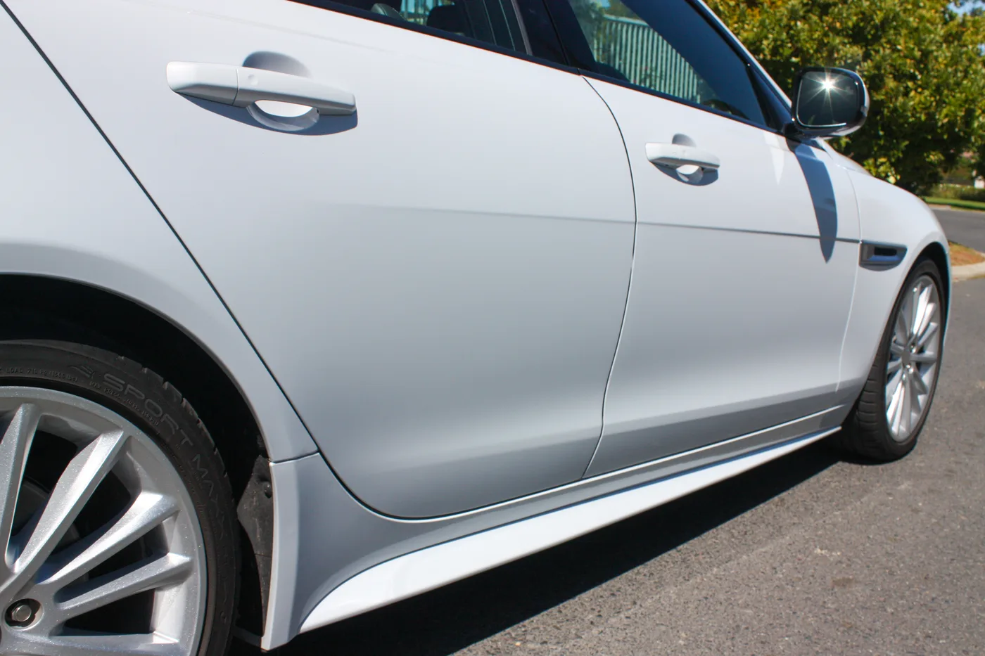 White sedan, side profile view